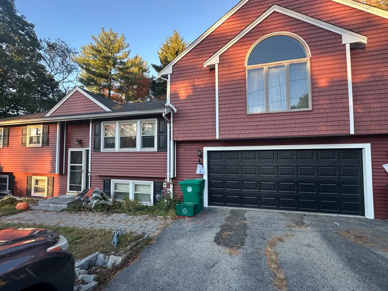 Red split-level house with a two-car garage
